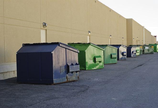 a variety of construction materials dumped haphazardly into a dumpster in Cantonment FL