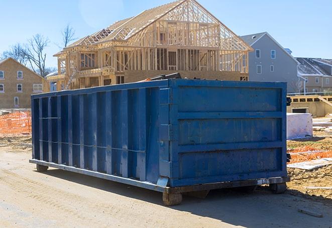 a dumpster for household garbage parked in a city street